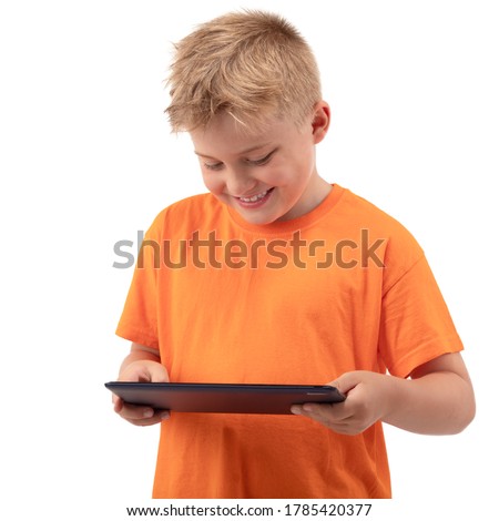 KID BOY USING MODERN DIGITAL TECHNOLOGIES BY WATCHING DIGITAL TABLET SCREEN ISOLATED ON WHITE BACKGROUND