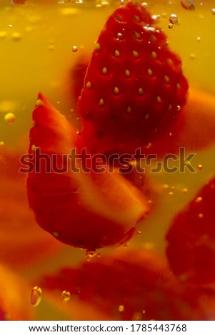 Background with pieces of strawberries in yellow jelly