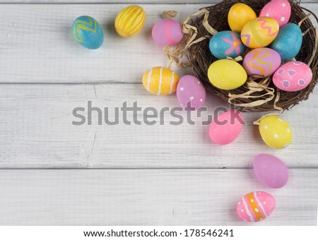 Easter Eggs in Nest from Top View Looking Down on White or Gray Rustic Wood Background with room or space for copy, text, words