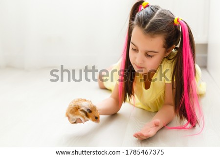 My little pal - girl holding her hamster in palms Royalty-Free Stock Photo #1785467375