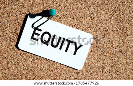 Equity on a white business card attached to a cork board.