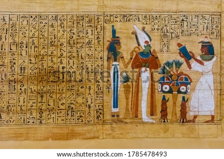 Egyptian ancient papyrus with different pictures and hieroglyphics Royalty-Free Stock Photo #1785478493