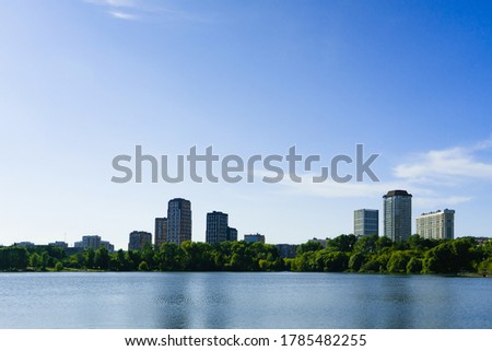view of tall houses in a cityscape across a body of water