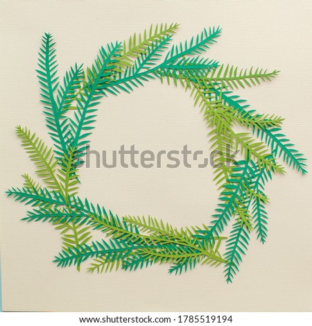 Handmade paper art Christmas wreath. On yellow background. Cutout. 