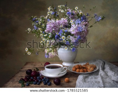 Still life with tea cup and bouquet of wildflowers
