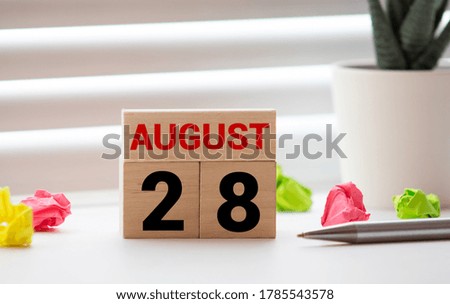 August 28th. Soft Selective focus on wooden block calendar on blurred wooden table and loft cement background with copy empty space for text.