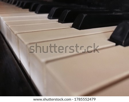 Keys on an old black piano