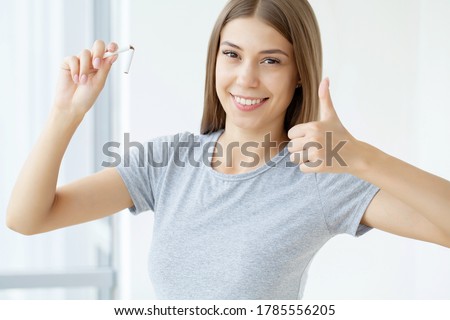 Stop smoking, woman holding a broken cigarette in her hand