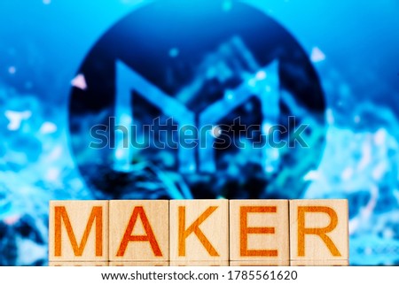 maker. wooden blocks with the inscription maker on the background of the cryptocurrency logo. defi concept
