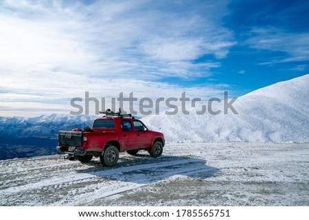 Red pickup truck on road, Beautiful winter road under snow mountains New Zealand. Royalty-Free Stock Photo #1785565751