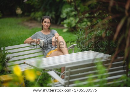 Young women drink coffee in the morning with a relaxing feeling in garden, In a coffee cup hand held, living at home concept