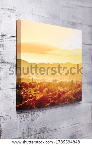 Canvas print on grey wooden background. Stretched canvas, gallery wrap. Summer sunset pic, landscape photography. Photo printed on canvas, perspective view