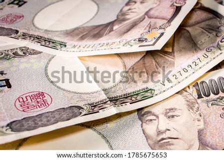 Close up of a couple of  Japanese 10000 yen banknotes on table.
