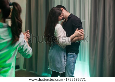 Cheerful young couple having a good time dancing at a party.