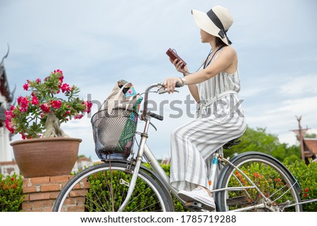 Tourist people holding audio guide for listen history culture.Tourism people ride bicycle for travel and listen meida audio for understand landmark  local building.