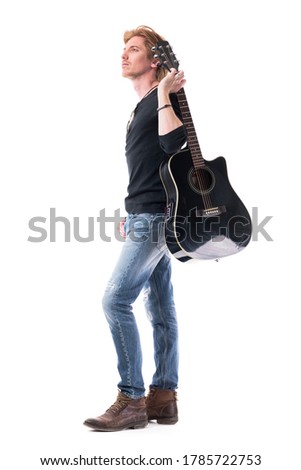 Confident young rocker man musician holding guitar looking up for inspiration ideas. Full body length isolated on white background. 