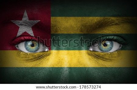 Human face painted with flag of Togo
