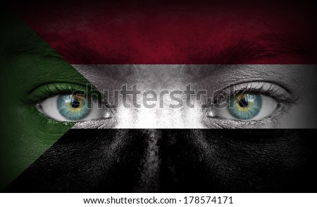 Human face painted with flag of Sudan