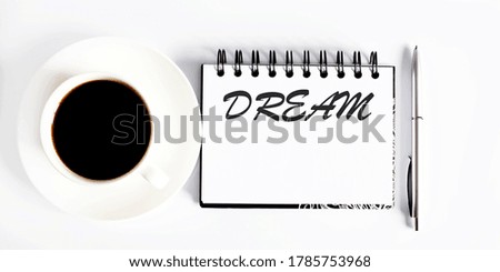 Business agenda, planning concept. Spiral notebook with DREAM text on white background with coffe