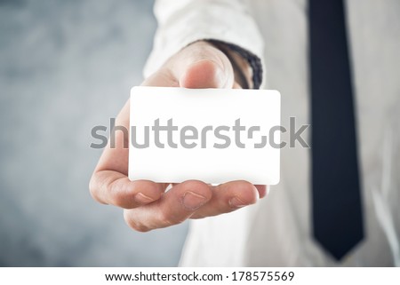Businessman holding blank visiting card with rounded corners. Selective focus. Blank  card with copy space for any title or design.