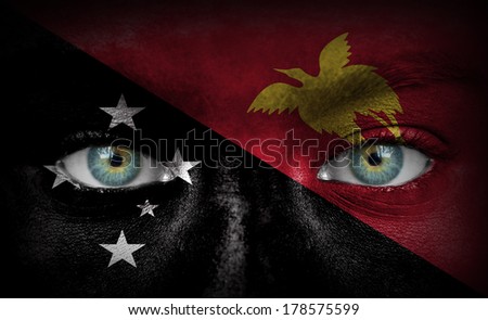 Human face painted with flag of Papua New Guinea