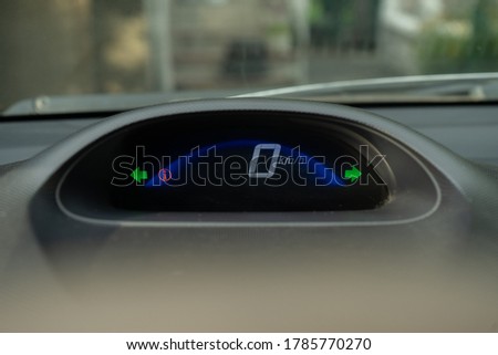 Vehicle, car hazard warning, two turn signals flashing on a dashboard