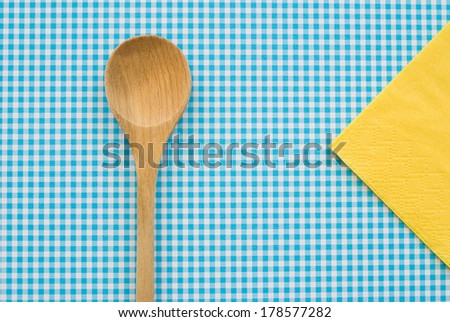 wooden spoon on coloured background