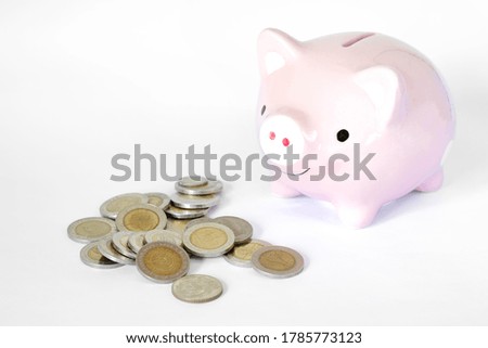Saving money concept, Piggy bank and coins stacks on white background.