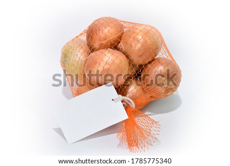 Onions in net bag with white tag placed on isolate background