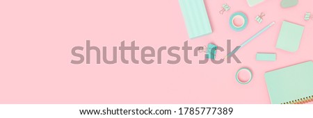 Frame made of school supplies on a pink pastel background. Creative banner with place for text.