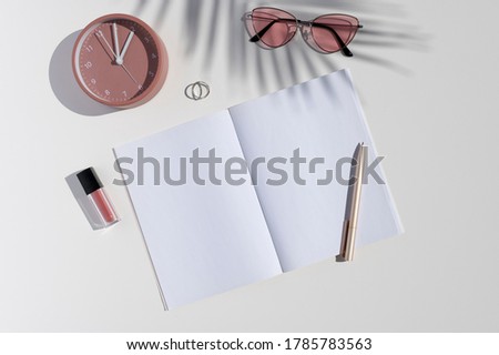 Feminine beauty blogger desk. Flat lay mockup with women's accessories, trendy palm leaf shadows and opened blank notebook. Copy space for text