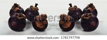 Fresh mangosteen fruit on white wooden board, panorama picture
