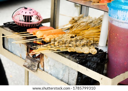 A picture of "lokcing" or Kelantanese fish satay been grilled on fire place.