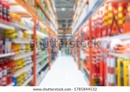 Blurred defocus shot of Hardware and industrial equipment display on shelf inside store and walkway aisle for customer selection. Background concept.