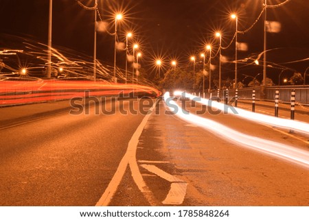 Long exposure night picture of the bridge in Ireland. Visible light streaks from passing cars. Picture taken by using point focus and exposure of 25 seconds. Picture is taken to show action and motion