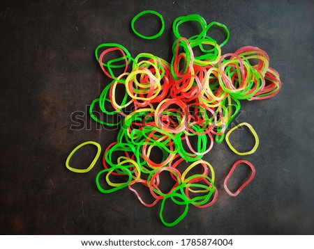 colorful rubber bands on workplace top view with vintage effect