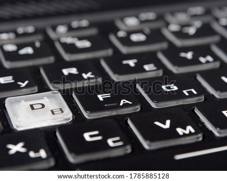 fashionable backlit laptop keyboard on dark background