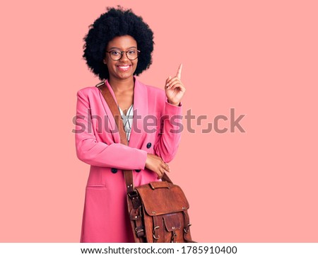 Young african american woman wearing business clothes and leather bag smiling happy pointing with hand and finger to the side 