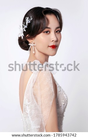 Noble Asian woman in white dress