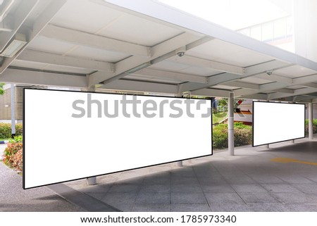 Edited visual for advertising billboard display at pedestrian walkway of MRT train station. Blank billboards of advertising space for mock up purpose; OOH ad placement