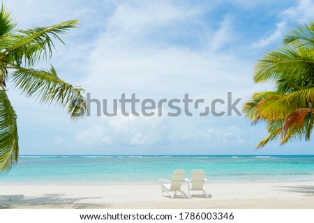 Blue sea white sand beach, nature tropical Palm Island. Caribbean sea and sky in Punta Cana. Little white beach chairs. Paradise landscape Island.