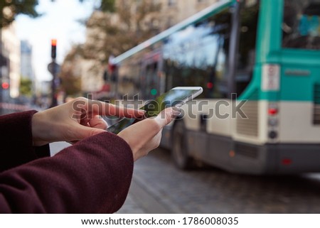 Woman using smartphone in the streets of Paris, France. Royalty-Free Stock Photo #1786008035