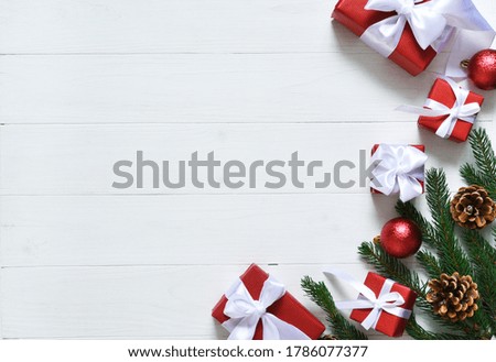 Christmas card. Christmas layout with boxes and fir on a white wooden background.