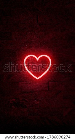 red neon heart on a stone wall