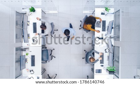 Top Down Shot of Big Busy Corporate Office with Two Rows off Businessmen and Businesswomen Working on Desktop Computers. Director is Walking Between Rows. Open Space Office with Businesspeople
