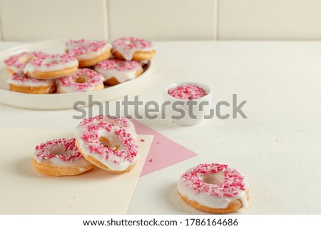 glazed donuts with pink sprinkles decoration