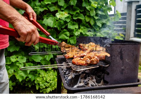 Preparing grilled food in the garden close up photo. Summer at home
