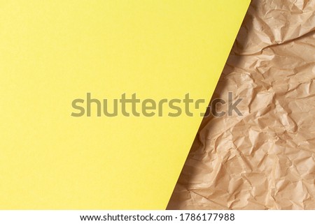 Abstract geometric paper texture background. Blank yellow color paper sheet over recycle crumpled brown paper background