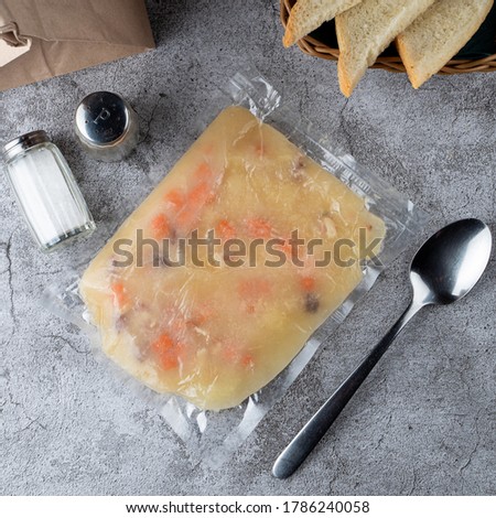 Bright yellow pea soup in a delivery package, plastic bag, is already cooked and ready to eat