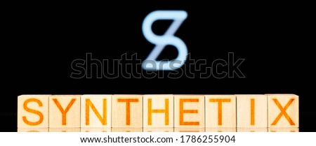Synthetix. wooden blocks with the inscription Synthetix on the background of the cryptocurrency logo. defi concept